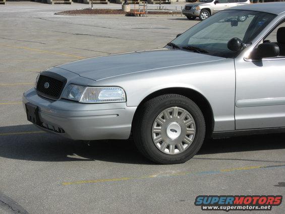 Silver sedan, front quarter view, showing grille, headlight, and wheel