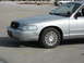 2004 Ford Crown Victoria - This silver sedan's body style suggests a model year of 2003, not 2004 as claimed.