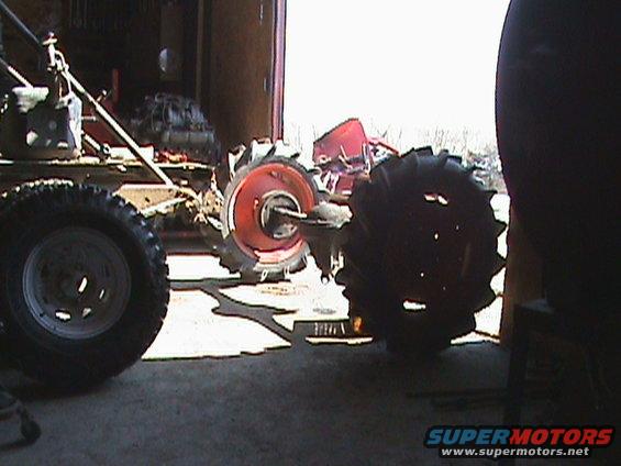 Tractor wheels and engine parts in a garage