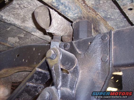 Underside view of a vehicle's exhaust pipe and suspension system