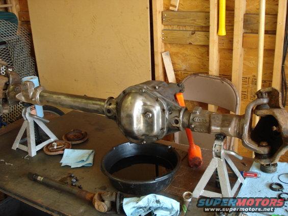 Ford Dana 50 front axle assembly on jack stands with oil pan