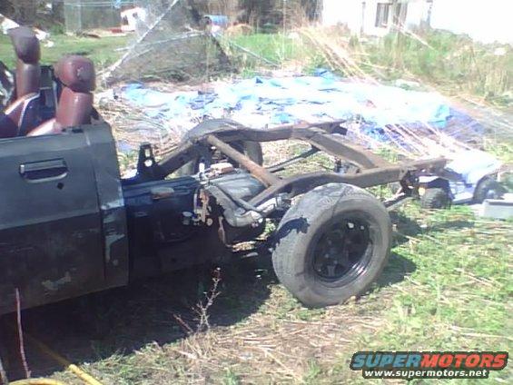 Truck chassis and partial cab, side view. Visible text: SUPERMOTORS.NET