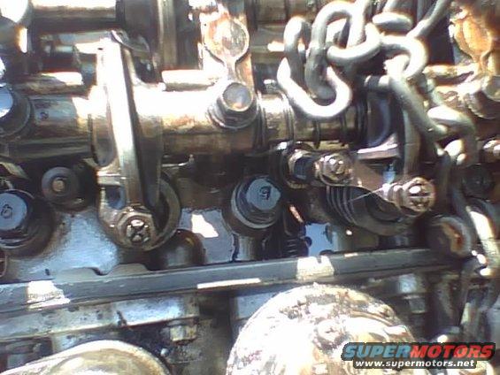 Close-up of engine valve train with rocker arms and springs visible