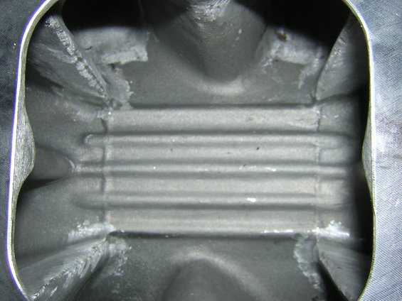 Close-up of the inside of an engine intake manifold with horizontal ridges