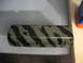 1985 Ford Crown Victoria LTD - A camaro valve cover painted with a tiger stripe camouflage pattern sits on a surface.