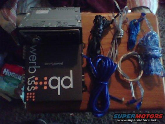 Car stereo and various wiring bundles on a wooden surface