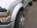 2008 Ford F-450 - Close-up of a silver dually truck's front passenger side, showing the fender, wheel, and running board.