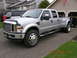 2008 Ford F-450 - Silver 2008 Ford F-450 Super Duty dually truck parked in a driveway with a house and garage in the background.