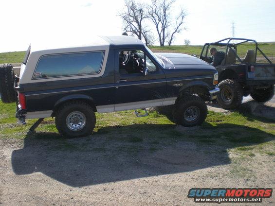 1993 Ford Bronco parked next to a Jeep off-road