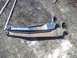 1979 Ford Bronco - A pair of old vehicle suspension control arms are shown resting on the dirt.