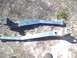 1979 Ford Bronco - Two blue metal automotive parts are shown on the ground.
