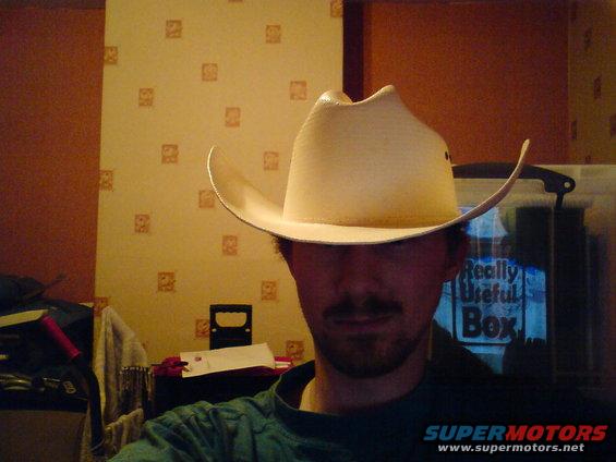 guy in a cowboy hat, with a box that says 'Really Useful Box' behind him