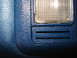1979 Ford Bronco - Close-up of blue interior trim with a map light and embossed text.