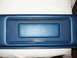 1979 Ford Bronco - A blue interior trim piece is shown, a recessed rectangular area and stitched detailing along the bottom edge.
