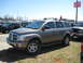 2004 Dodge Durango - A tan 2004 Dodge Durango SUV is parked on a grassy lot with other vehicles visible.