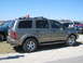 2004 Dodge Durango - Side view of a 2004 Dodge Durango SUV with a red flag on its roof rack.