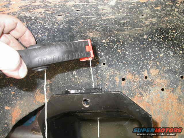 Using a spring clamp to hold the plumb bob string makes it much easier to adjust the plumb bob height quickly.