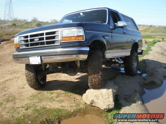 Dark blue 1993 Ford Bronco on rocks