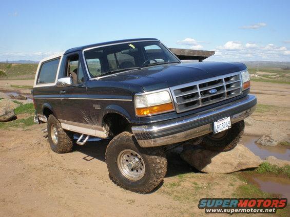 1993 Ford Bronco on rocks with front wheel elevated