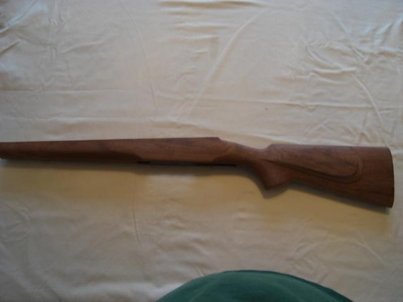 Wooden rifle stock on a white cloth background