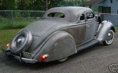 1936 Ford Coupe with a spare tire mounted on the rear, showing a license plate E20-508