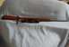 1991 Ford Bronco - A bolt-action rifle with a wooden stock and a scope is laid out on a blue cloth.