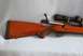 1991 Ford Bronco - Wooden stock rifle with a scope is shown from the side.