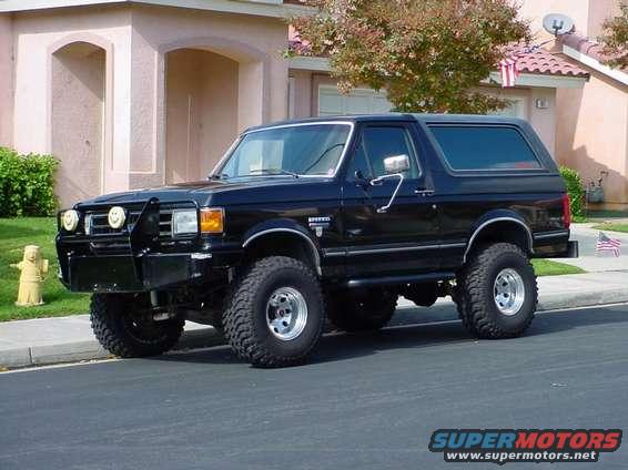 Black 1991 Ford Bronco with custom bumper and off-road tires