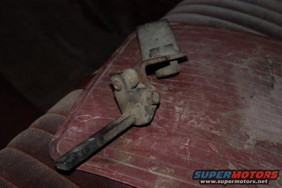Transfer case shifter lever on red patterned upholstery