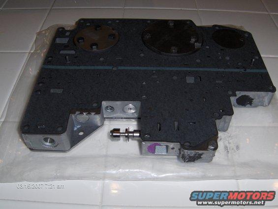 Transmission valve body with metal and plastic components. Date stamp reads 08/16/2007