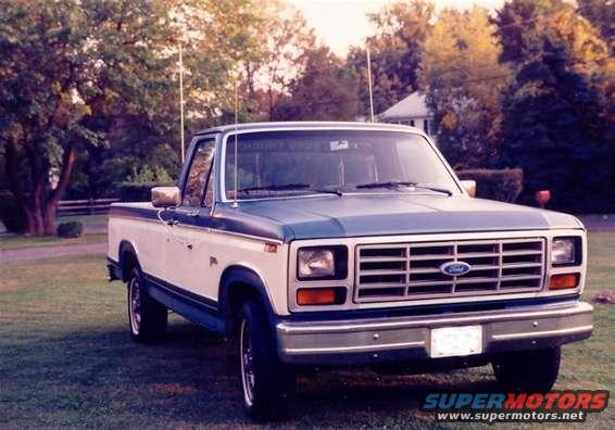 1980-1986 Ford F-Series pickup truck, blue and white two-tone paint, parked on grass