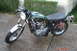 2006 Honda CBR-RR - A vintage green motorcycle with a black seat and chrome accents is parked outdoors on a paved surface.
