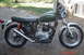2006 Honda CBR-RR - A vintage Yamaha motorcycle with a green fuel tank and chrome accents is parked outdoors.