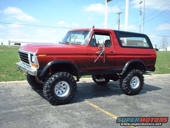 Red 1979 Ford Bronco with lifted suspension and large tires