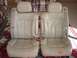 1983 Ford Bronco - Two tan leather car seats are shown from the front, placed on a rug.