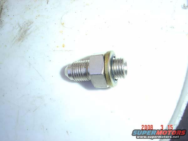 Metal fitting with threads and a nut, on a white surface. Watermark reads '2008 3 15 SUPERMOTORS.NET'