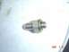 1983 Ford Bronco - Close-up of a metal fitting with threads and a nut, likely a plumbing or automotive part.