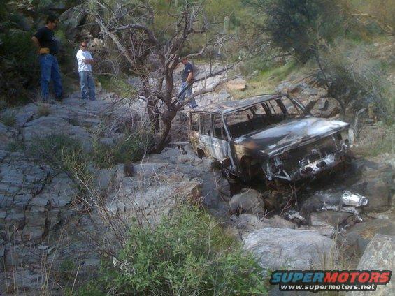 Burnt out SUV in rocky terrain