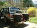 1991 Ford Bronco - 1991 Ford Bronco carrying spare tires on a rear hitch carrier.