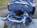 1964 Ford Galaxie - The front end of a car, with the engine bay covered and the chassis supported by jack stands, is shown in a state of disassembly.