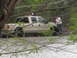 1996 Ford Bronco - A tan Ford F-250 Super Duty is stuck in water with two people nearby.