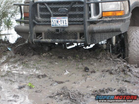 Ford truck stuck in mud, front end visible with bull bar and license plate 51M-YV1
