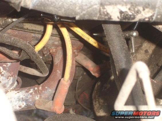 Yellow spark plug wire with "RADIO SUPPRESSION CORE" text