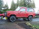 1985 Ford Bronco II - Red 1985 Ford Bronco II parked outside with a boat trailer visible in the background.