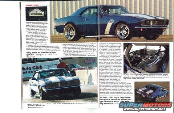 Blue 1967 Chevrolet Camaro with white stripes and racing wheels, shown from the front 3/4 view. A second Camaro is visible in the background