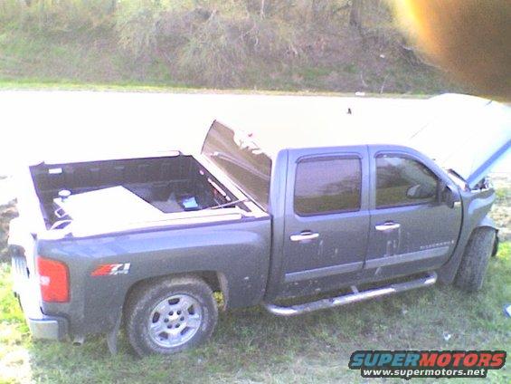 Dark gray crew cab pickup truck, hood open, Z71 badging visible on fender