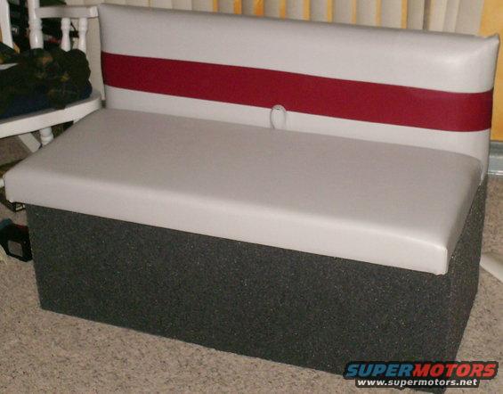 boat seat with gray cushion and white backrest with red stripe