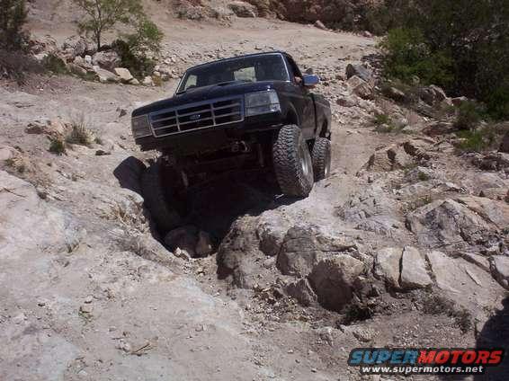 Black 1992 Ford F-150 navigating a rocky trail