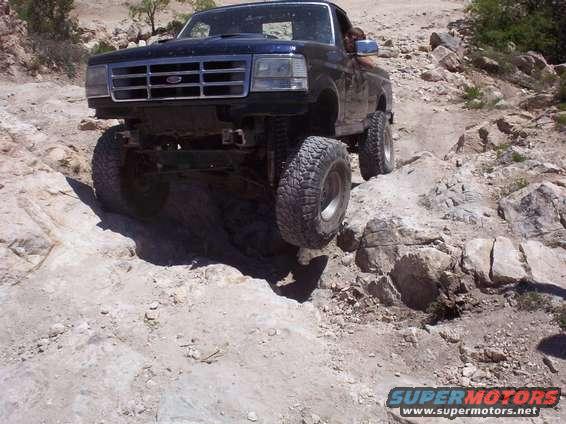 1992 Ford F-150 driving on rocky terrain, front 3/4 view