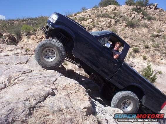 1992 Ford F-150 climbing over large rocks on a dry, hilly landscape